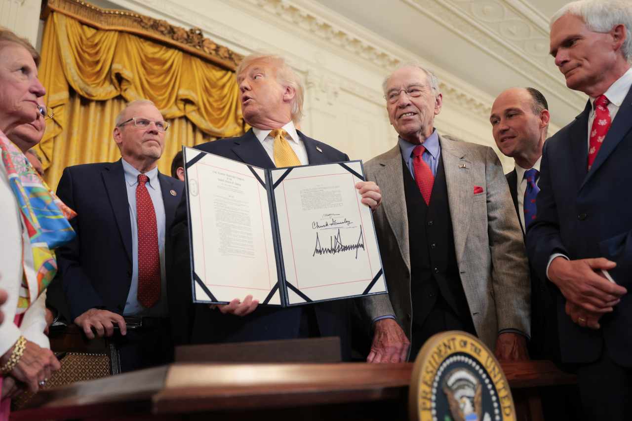 Trump signs the Genius Act into...